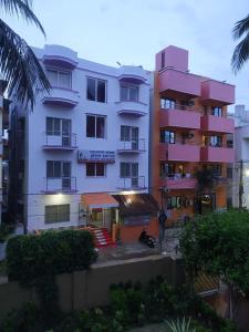 a view of a building with palm trees at Hotel Swagat in Puri