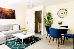 a living room with a couch and a table at Livingston North Station Apartments in Livingston