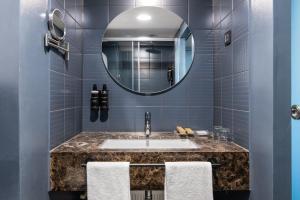 a bathroom with a sink and a mirror at Exe Lev in Ljubljana