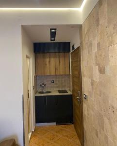 an empty kitchen with a sink and a counter at Hotel Comfort & Villas in Donji Štoj