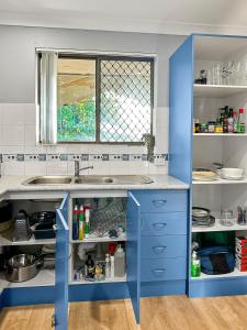 a kitchen with blue cabinets and a sink at Family Home Close To All Perth Adventures in Hamilton Hill