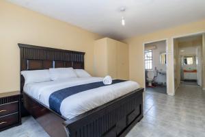 Un dormitorio con una cama grande en una habitación. en Rosa Luxury Villa near Jomo Kenyatta International Airport-JKIA, en Nairobi