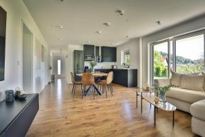 a living room with a couch and a table at Ferienwohnung Hohenstein in Murrhardt