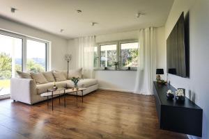 a living room with a couch and a table at Ferienwohnung Hohenstein in Murrhardt