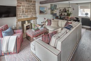 a living room with two couches and a fireplace at The Little Cottage in Chapel Stile