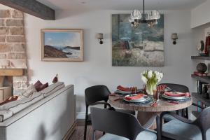 a dining room with a table and a couch at The Little Cottage in Chapel Stile