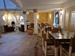 - un restaurant avec des tables et des chaises dans une salle dans l'établissement Dar Nafoura-Mogador, à Essaouira