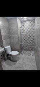 a bathroom with a toilet and a shower at Hotel el Fawz in Monastir