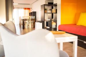 a living room with a bed and a table at Beach Apartment in Faro