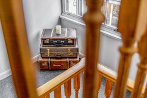two suitcases stacked on the floor in a room at The Rooftops in Boston