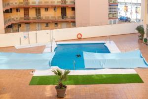 a large swimming pool in a building at LXR Nogalera 1 HAB Céntrico in Torremolinos