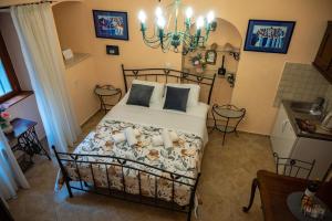 a bedroom with a bed and a chandelier at Amoret Apartments in Dubrovnik