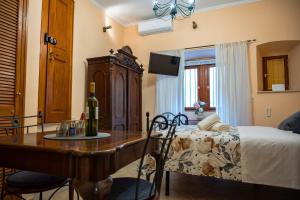 a bedroom with a bed and a table with a bottle of wine at Amoret Apartments in Dubrovnik