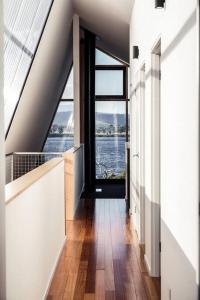 an attic hallway with a view of the water at Apollo Bay House in Woodbridge