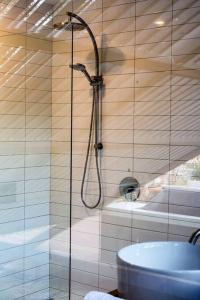 a bathroom with a shower and a sink at Apollo Bay House in Woodbridge