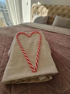 a heart on a blanket on a bed at FRIENDLY HOME in Tuzla