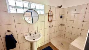 a bathroom with a sink and a mirror at Fawlty Towers Accommodation & Activities in Livingstone