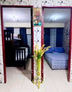 a bedroom with a bed and a door with flowers in it at 2bedroom condo unit in Manila