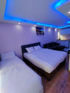 two beds in a room with a blue light at BlueRoyal Grand Bazaar in Istanbul