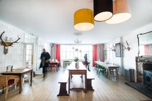 a room with tables and chairs and a fireplace at MHOR 84 in Kingshouse