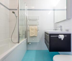 a white bathroom with a sink and a shower at Haus Alpenglück in Saas-Fee +31 photos