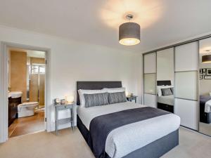 a bedroom with a large bed and a bathroom at 1 bed property in Harrogate North Yorkshire HH097 in Harrogate
