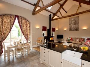 a kitchen and living room with a couch and a table at 1 Bed in Ripon G0127 in Kirkby Malzeard