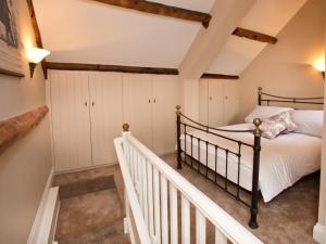 a bedroom with a bed and a staircase at 1 Bed in Ripon G0127 in Kirkby Malzeard