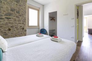 a bedroom with a large bed and a window at Ledro Lake Suites in Ledro