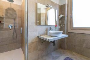 a bathroom with a sink and a shower at Ledro Lake Suites in Ledro
