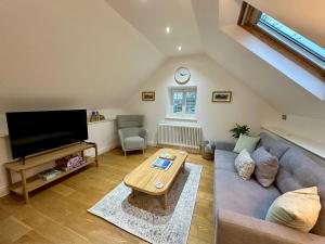 a living room with a couch and a table at Lilimae Barn in Ashbourne