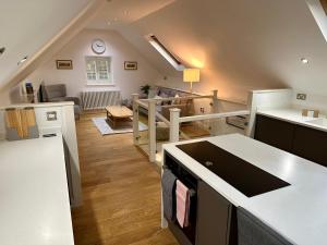 a large kitchen and living room with a staircase at Lilimae Barn in Ashbourne