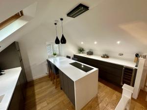 a kitchen with a white counter and a kitchen island at Lilimae Barn in Ashbourne