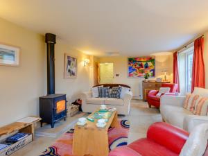 a living room with a wood stove in it at 4 Bed in Isle of Purbeck 78042 in Kingston