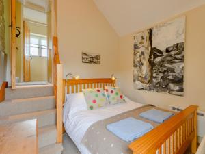 a small bedroom with a bed and a staircase at 4 Bed in Isle of Purbeck 78042 in Kingston