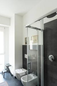 a bathroom with a shower and a toilet and a sink at Youhosty - Soderini 25 in Milan