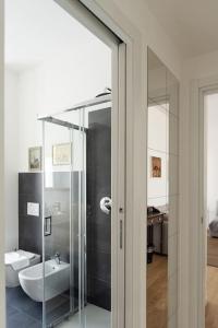 a bathroom with a glass shower and a sink at Youhosty - Soderini 25 in Milan