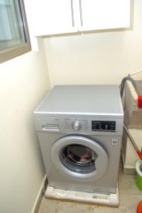 uma máquina de lavar roupa num canto de um quarto em Three Cozy Bedrooms at Palm Ridge em Vipingo