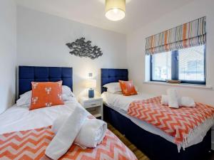 a bedroom with two beds and a window at 2 Bed in Westward Ho 77289 in Northam