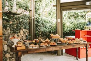 a table with a bunch of food on it at Hotel della baia - Negombo Parco Termale in Lacco Ameno