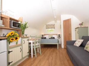 a kitchen and living room with a couch and a table at 1 Bed in Teviothead 75346 in Hawick