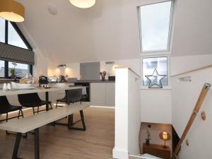 a kitchen and dining room with a table and chairs at 3 Bed in Westward Ho 76533 in Northam