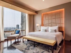 a bedroom with a large bed and a large window at VIE Hotel Bangkok, MGallery in Bangkok