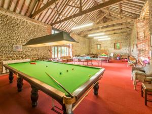 a pool table in the middle of a room at 2 bed in Tatterset 77765 in Tattersett