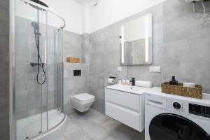 a bathroom with a shower and a toilet and a sink at Mickiewicza Charming Studio for 2 Guests by Renters in Krakow
