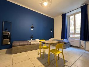 - une chambre avec un lit, une table et des chaises dans l'établissement Palladini Hostel Rome, à Rome