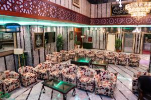 a room with couches and tables in a room at فندق برج العالم in Mecca