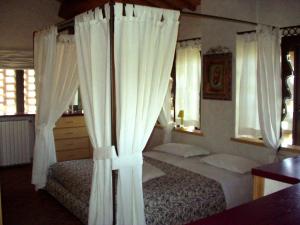 a bedroom with two beds with white curtains at Il Cigliere your holiday home in the heart of Tuscany in Florence