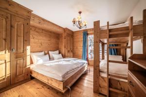 a bedroom with two bunk beds and a chandelier at Ayous Verbier - BY EMERALD STAY in Verbier