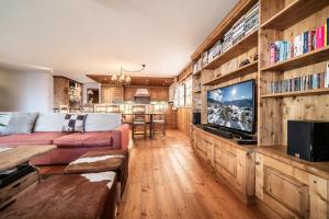 a living room with a couch and a tv at Ayous Verbier - BY EMERALD STAY in Verbier